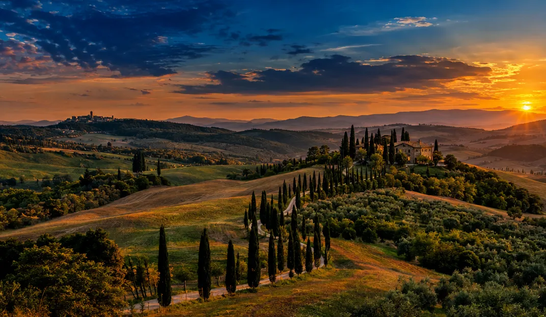 Tuscan hills with cypress trees at dusk